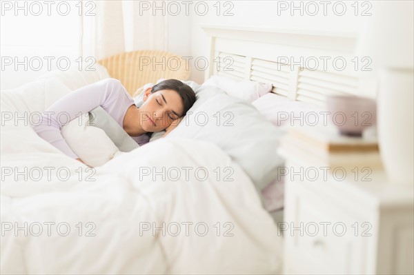 Woman sleeping in bed.