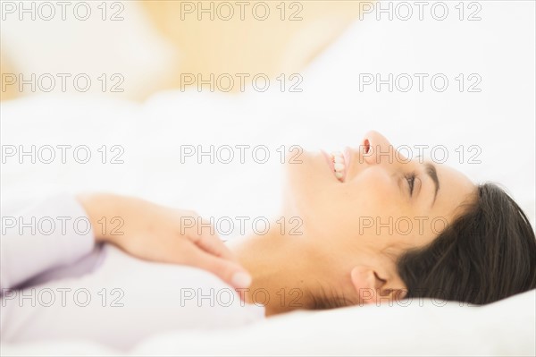 Woman lying in bed.