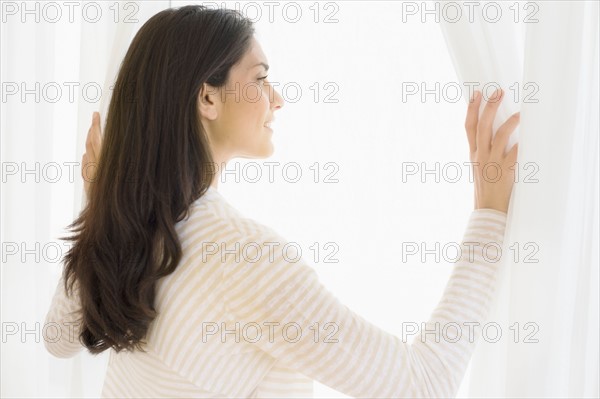 Woman looking through window.