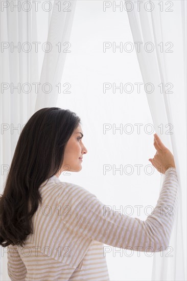 Woman looking through window.