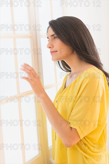 Woman looking through window.