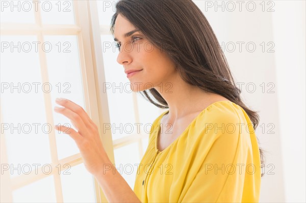 Woman looking through window.