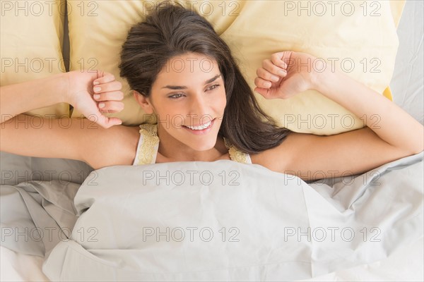Woman lying in bed.