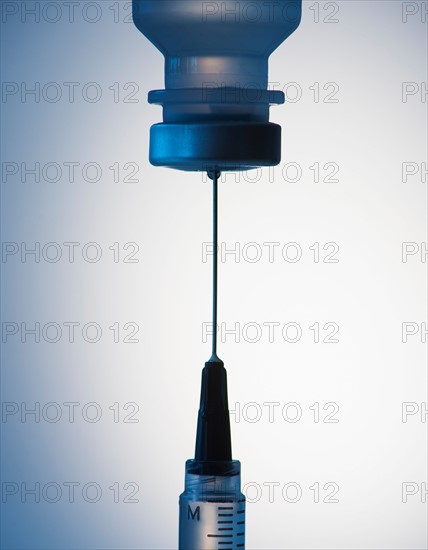 Close up of syringe and medication, studio shot.