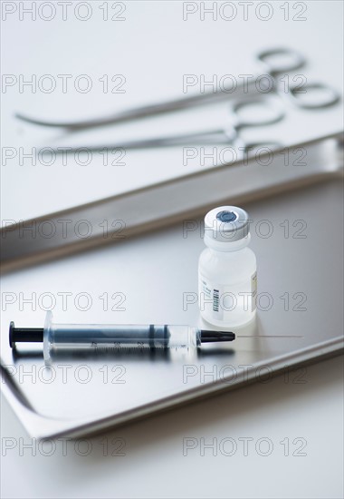 Close up of syringe and medication, studio shot.