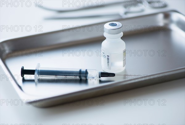 Close up of syringe and medication, studio shot.