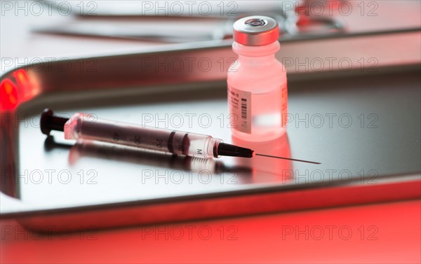 Close up of syringe and medication, studio shot.