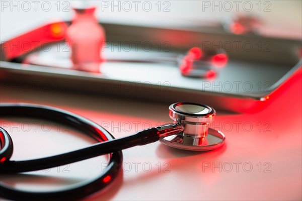 Close up of stethoscope and medication, studio shot.