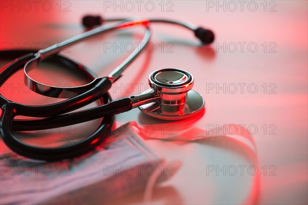 Close up of stethoscope and surgical mask, studio shot.