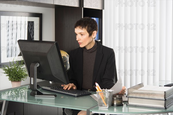 Businesswoman working at desk.