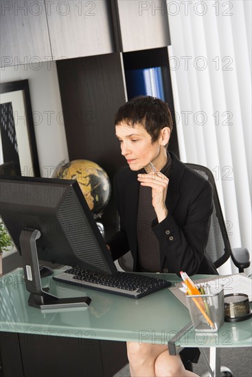 Businesswoman working at desk.