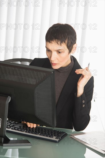 Businesswoman working at desk.