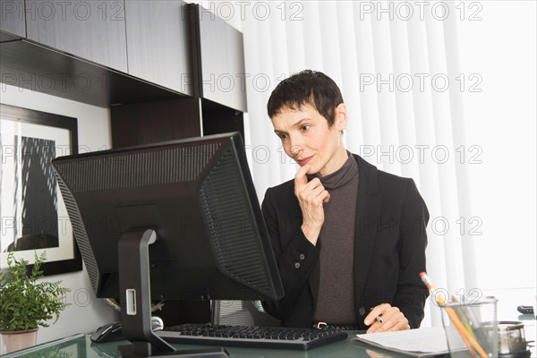 Businesswoman working at desk.