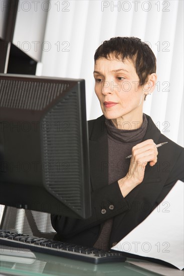 Businesswoman working at desk.