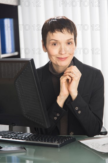 Portrait of businesswoman at desk.