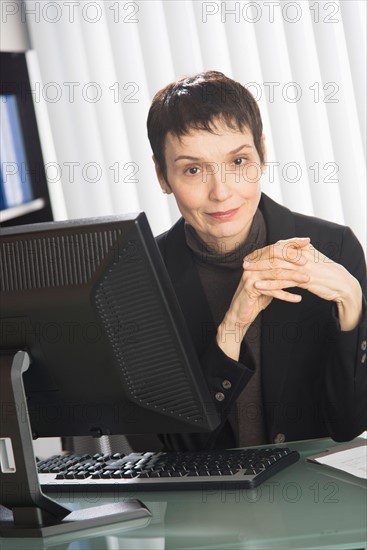 Portrait of businesswoman at desk.