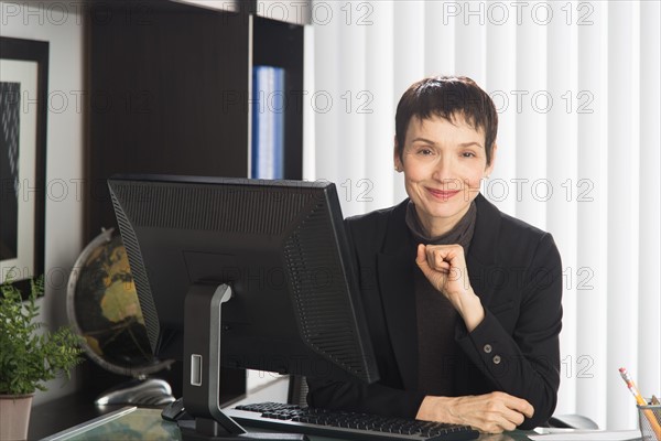 Portrait of businesswoman at desk.