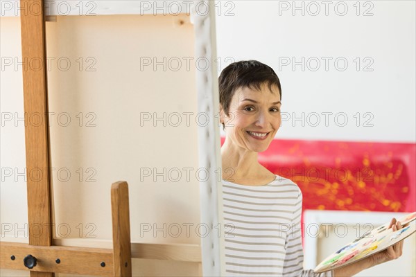 Portrait of female artist in her studio.