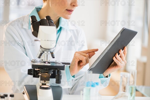 Woman using digital tablet in laboratory.