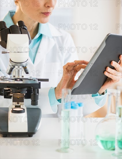 Woman using digital tablet in laboratory.