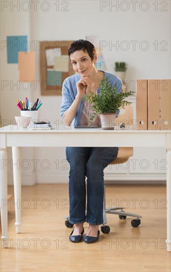 Portrait of woman in home office.