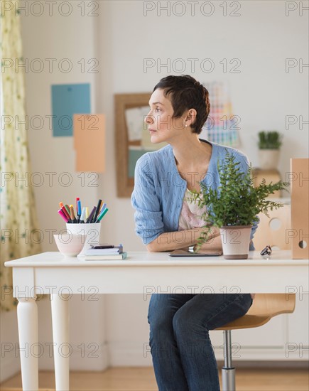 Woman sitting in home office.