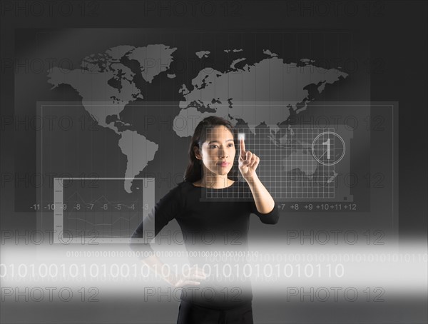 Woman touching high tech screen, studio shot.