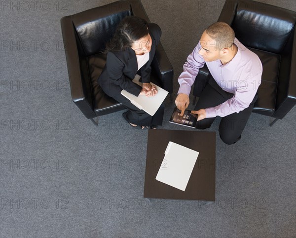 Man and woman at meeting in office seen from above.