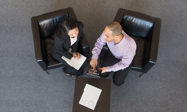 Man and woman at meeting in office seen from above.