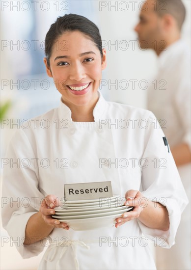 Couple during preparations in kitchen of their own restaurant.