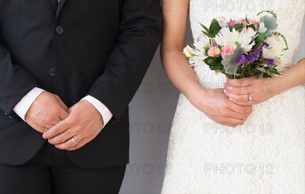 Close-up of bride and groom standing side by side.