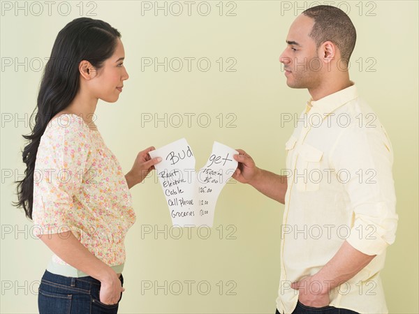 Young couple fighting over home budget.