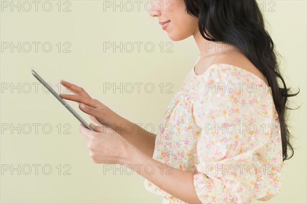 Young woman using digital tablet.