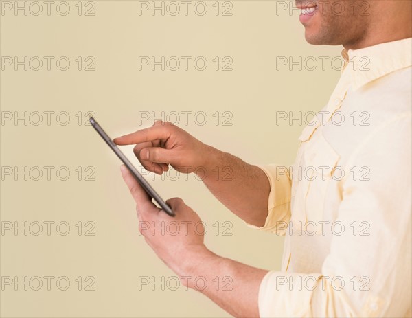 Young man using digital tablet.