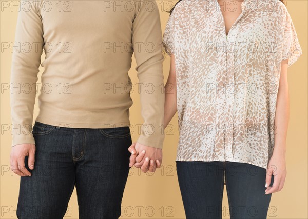 Young couple holding hands.