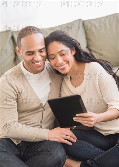 Young couple using digital tablets.