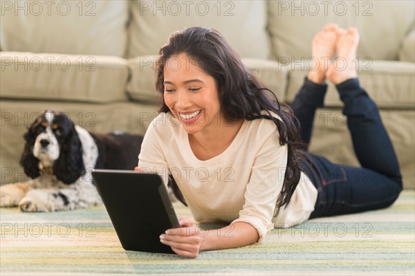 Young woman with dog in livingroom.