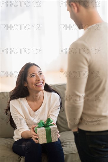 Woman receiving wrapped present.