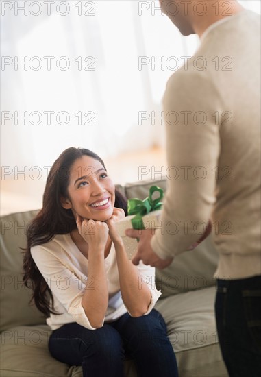 Woman receiving wrapped present.
