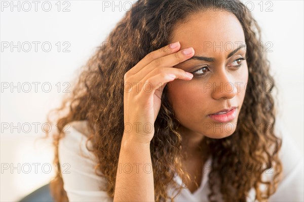 Office worker sitting by desk with laptop.