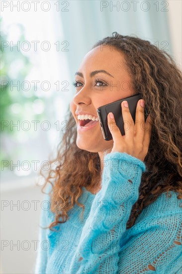 Young woman talking on phone.