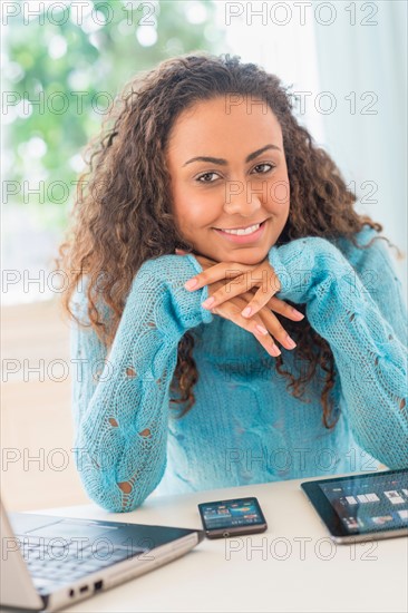 Young woman using laptop at home office.