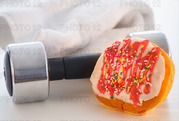 Studio Shot of jelly doughnut and hand weight