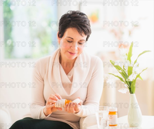 Portrait of mature woman taking pills