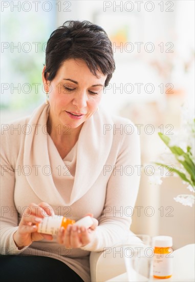 Portrait of mature woman taking pills