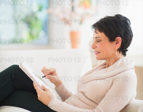 Portrait of mature woman drawing