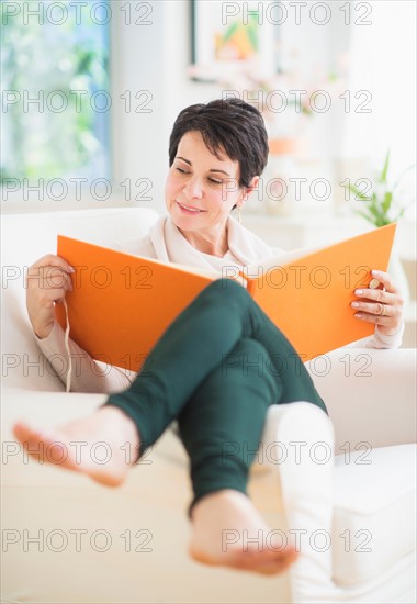Portrait of mature woman looking at photo album