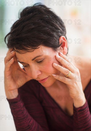 Portrait of mature woman with hands on head