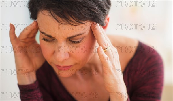 Portrait of mature woman with hands on head