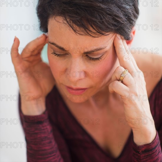 Portrait of mature woman with hands on head